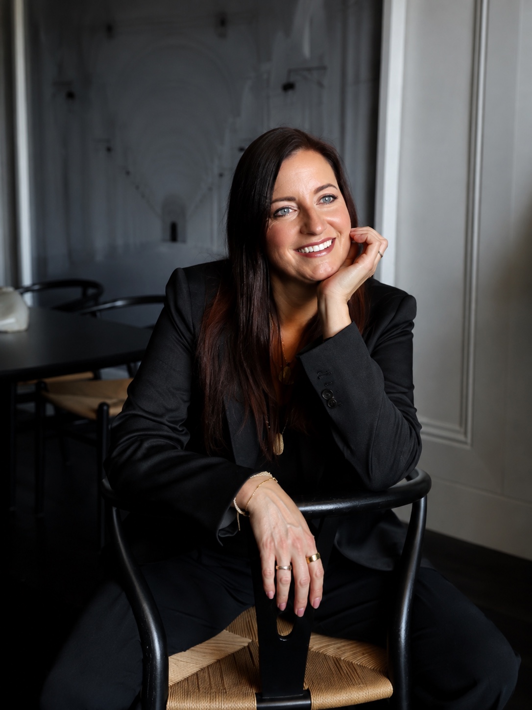Kristin Kuipers seated in a black blazer, smiling